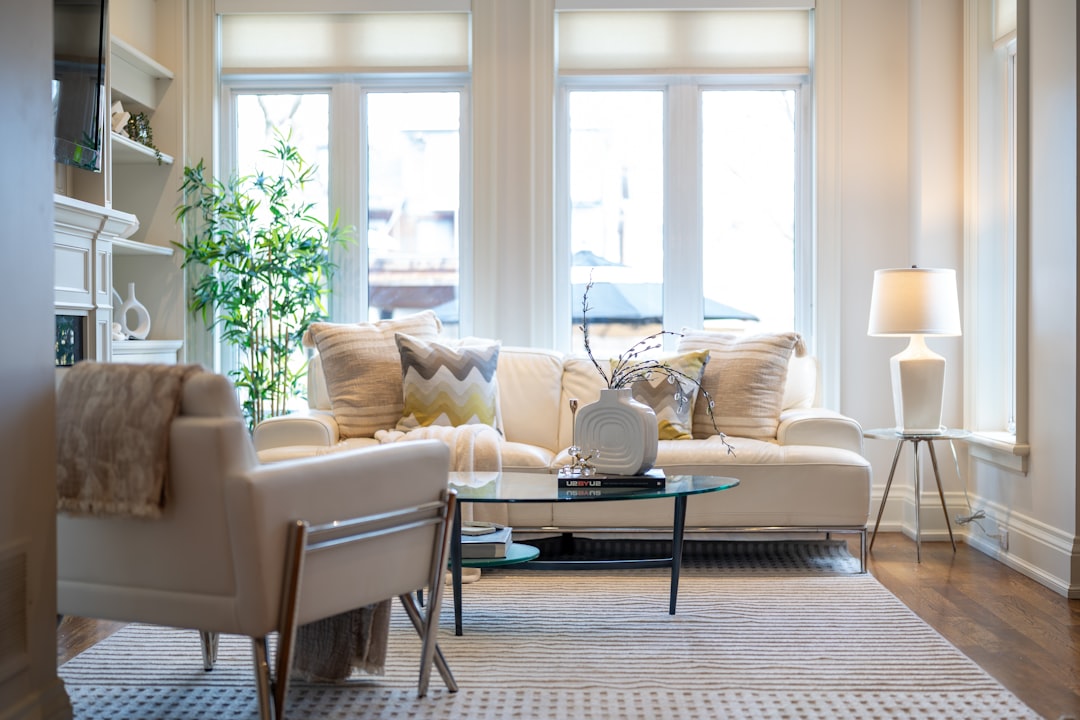 A bright, comfortable living room with an armchair and sofa